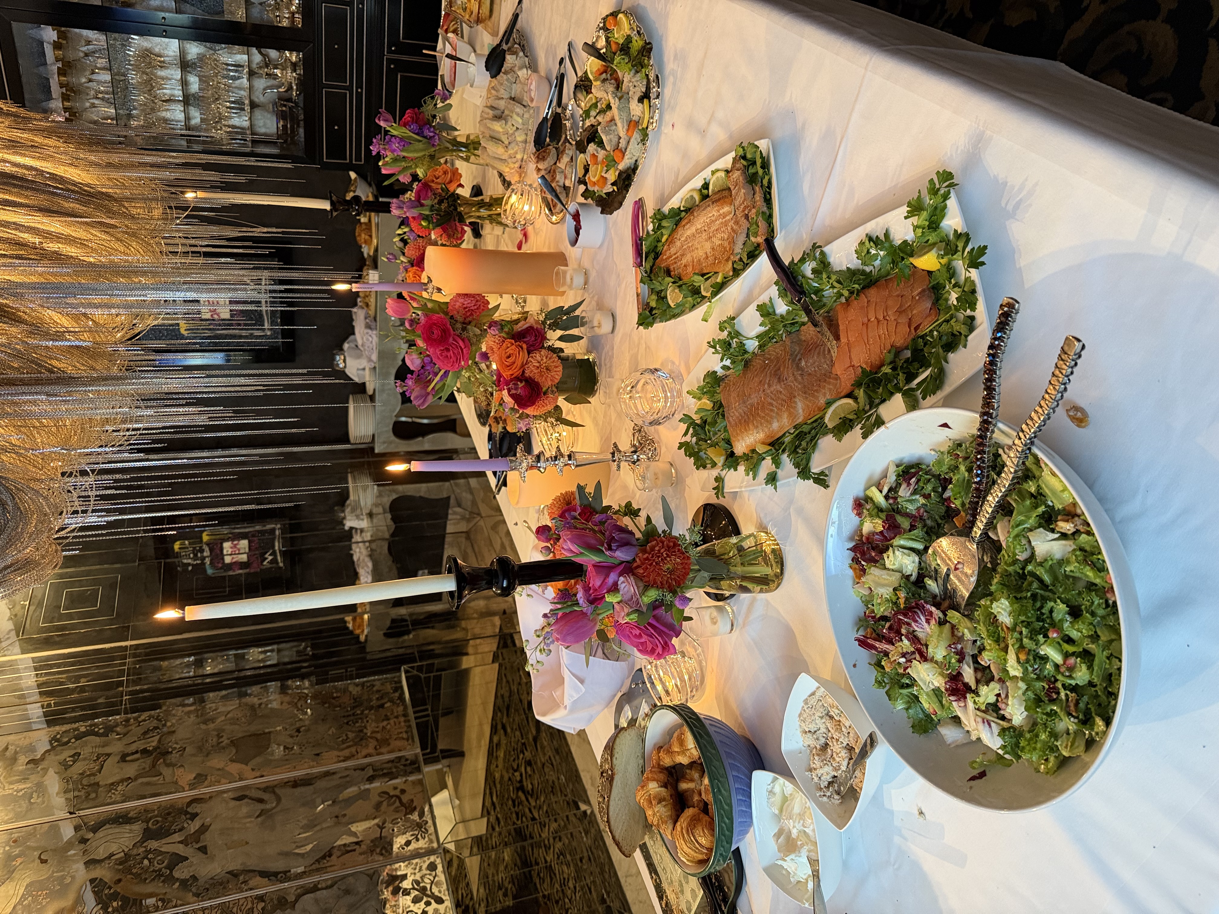 A holiday table from the Festive Feasts chapter of Love What's On Your Plate: rack of lamb, ceviche, a raspberry almond flan and candles